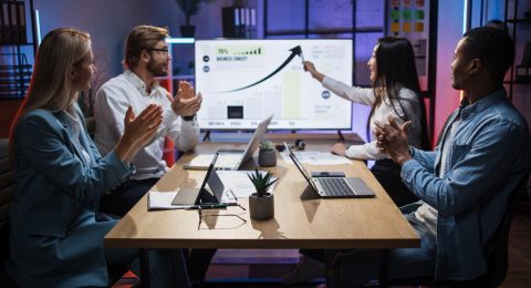 Asian woman showing financial report for colleagues