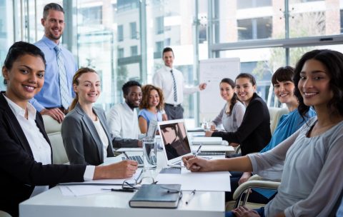 Portrait of happy businesspeople working in office