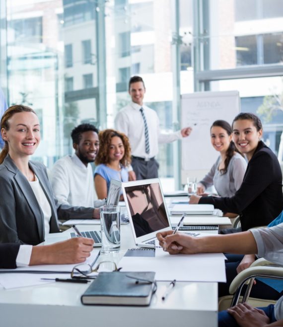 Portrait of happy businesspeople working in office