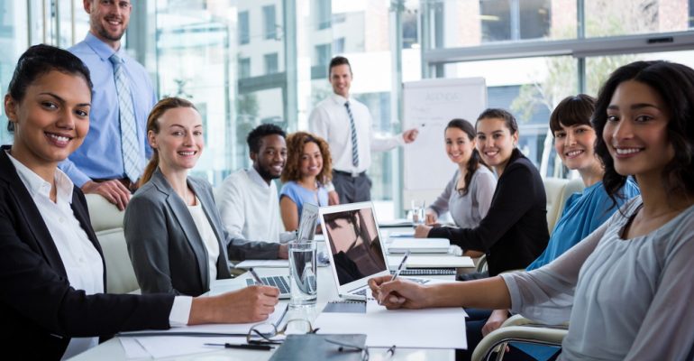 Portrait of happy businesspeople working in office