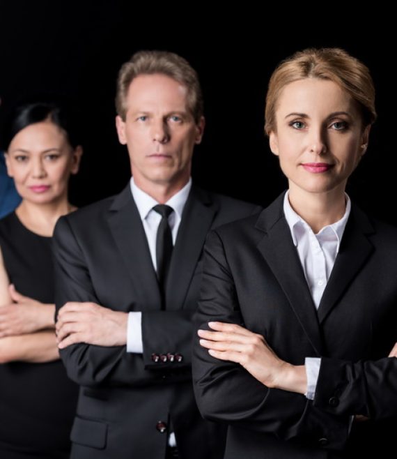 confident multiethnic group of businesspeople standing with cros