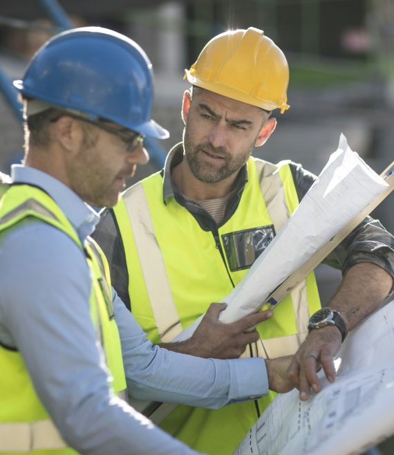 Project manager and construction worker looking at plans