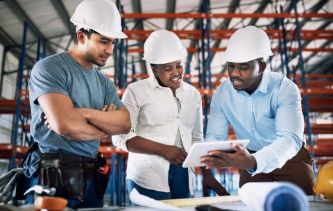Shot of a group of builders having a meeting at a construction site.