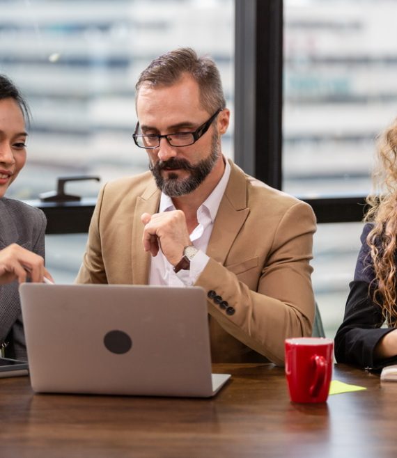 Group of businesspeople watching financial report on computer la