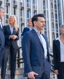 Senior Executives Talk Business While Descending Stairs in Office Building
