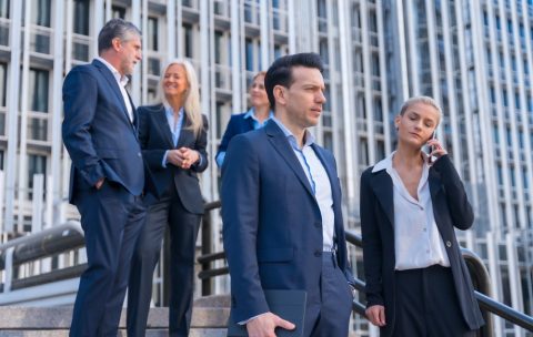 Senior Executives Talk Business While Descending Stairs in Office Building