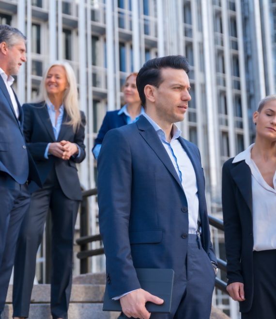 Senior Executives Talk Business While Descending Stairs in Office Building