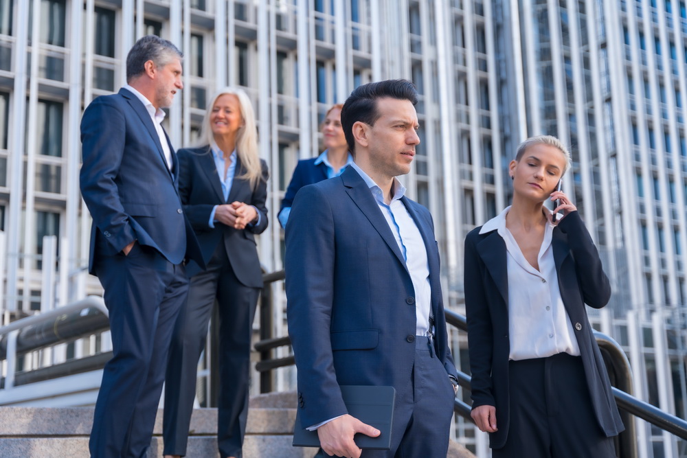 Senior Executives Talk Business While Descending Stairs in Office Building